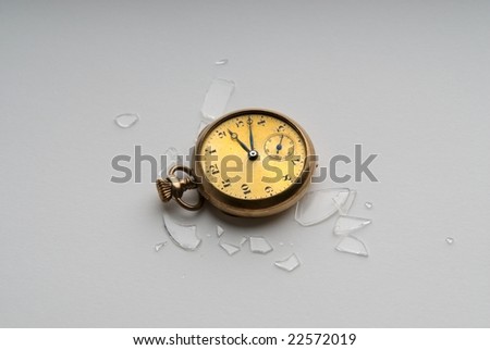 An image of a pocket watch broken on the ground