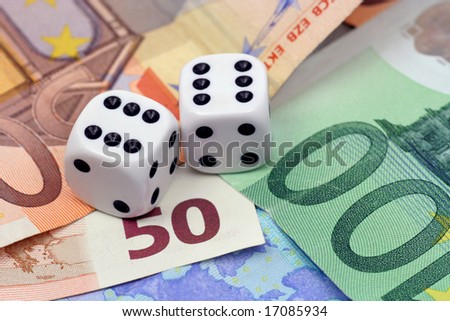 Two dices thrown on euro money - financial concept