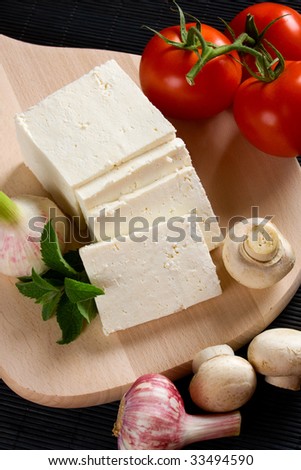 White cow\'s cheese slices with tomato and mushrooms