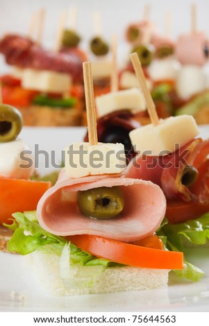 Mediterranean cold buffet canape with ham, olive, cheese and tomato