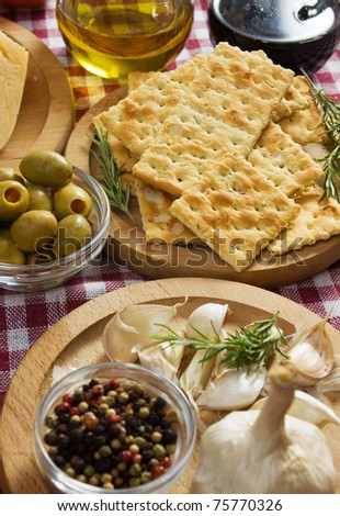 Salty crackers with olives, garlic and other mediterranean food ingredients