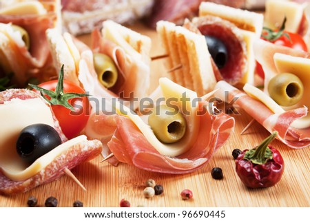 Prosciutto, Salami, Cheese And Olive Canape Appetizer On Wooden Board ...