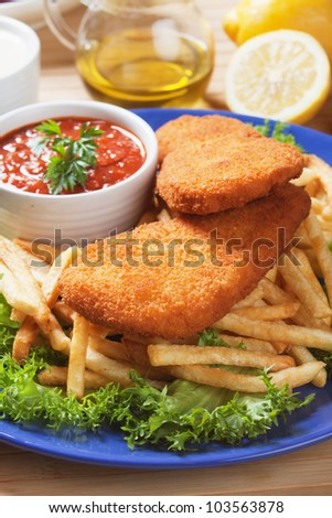 Breaded fish and french fries with chili sauce
