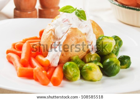 Jacket potato with cream sauce, baby carrot and brussel sprout