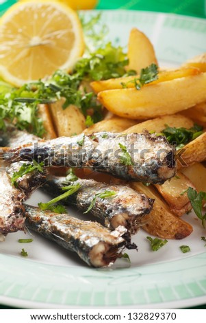 Grilled sardine fish with fried potato wedges