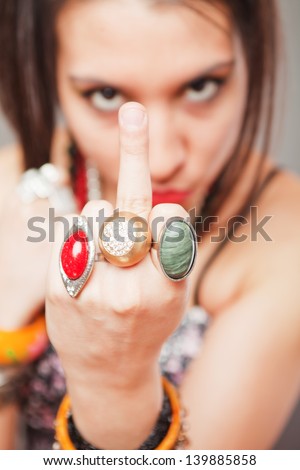 Young girl showing middle finger, rude and offensive gesture