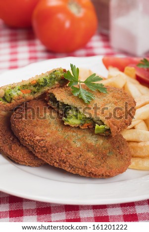 Breaded vegetable steak or burger with french fries