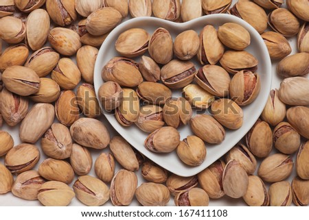 Roasted pistacchio, healthy snack in heart shaped tray