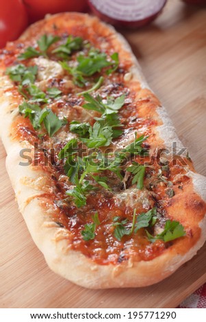 Plain homemade italian pizza with tomato sauce and herbs