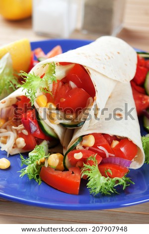 Vegetarian tortilla wraps with tomato, corn and lettuce