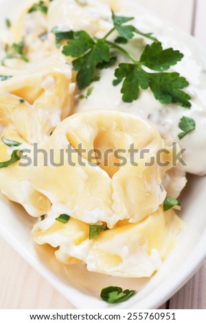 Italian tortellini pasta with cheese sauce and parsley