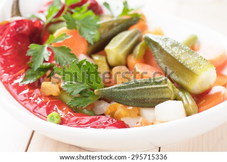Healthy vegan meal with okra, bell pepper and cooked vegetables