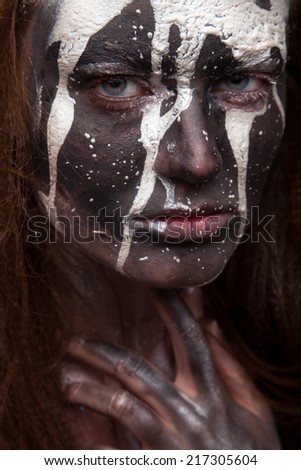 woman portrait with flowing white paint and dark face art