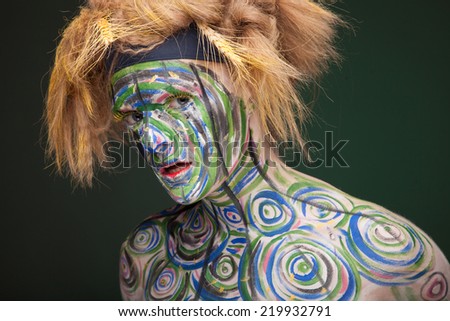 Portrait of young beautiful woman with traditional african tribal face paint