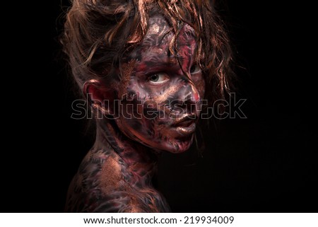 Portrait of the beautiful girl with dark painted face art