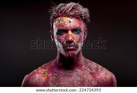 A creepy portrait of a halloween man with bloody body art and face art.