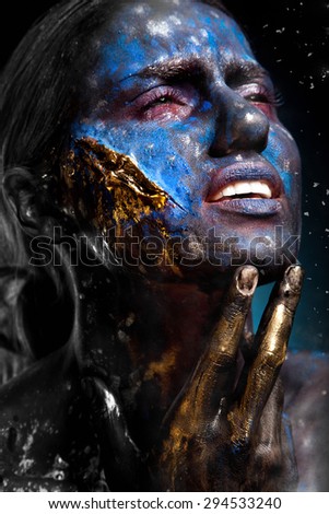 Surreal portrait of a woman female creature alien with hands holding her head on cosmic background. symbolizes our feebleness and impotency in front of the hands of fortune or fate