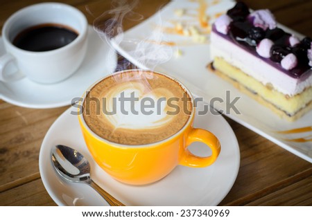 coffee late art on table with blueberry cake