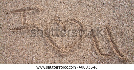 Writing in the sand spells out I Heart You in oahu hawaii.