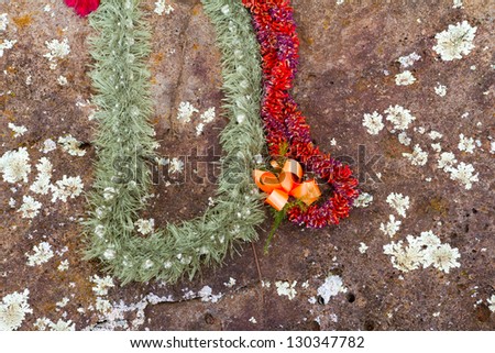 These beautiful flower leis have been placed on the birthing stones in Hawaii on the north shore of Oahu. These historical rocks are the site of where many native queens and kings have been born.
