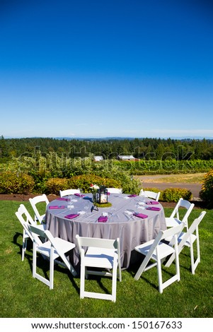 Tables, chairs, decor, and decorations at a wedding reception at an outdoor venue vineyard winery in oregon.