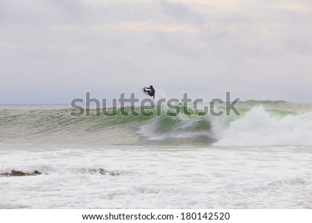 LA JOLLA, CA - JANUARY 30, 2014: Professional surfer Skip McCullough surfing a wave in La Jolla, CA during a surf session.