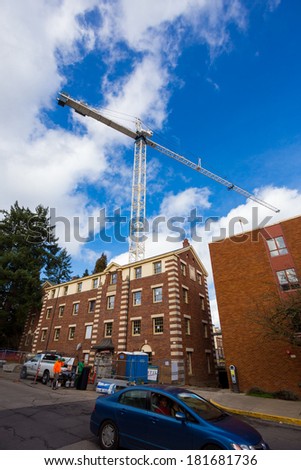EUGENE, OR - MARCH 4, 2014: Building construction on the University of Oregon campus with a crane extending into the sky.