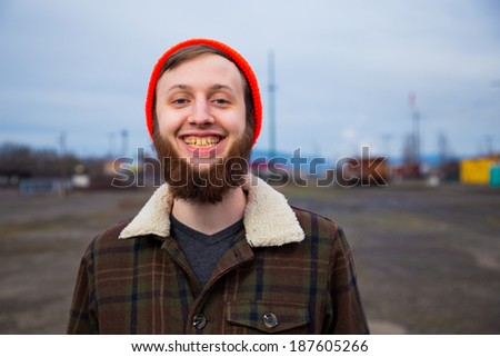 Modern, trendy, hipster guy in an abandoned train yard at dusk in this fashion style portrait.