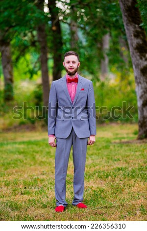 Fashionable groom on his wedding day outdoors just before the ceremony.