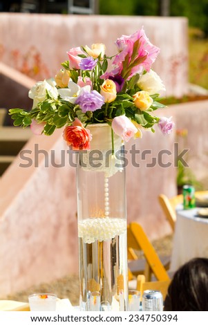 Wedding reception decor with flower center pieces on tables.