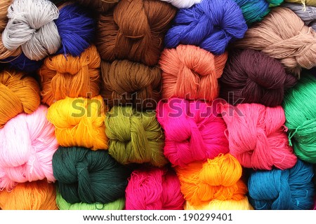 Colorful skeins of dyed wool for sale at the outdoor craft market in Otavalo, Ecuador