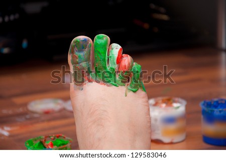 Man foot painted by red, green, blue color. Man Pedicure.