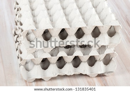 Eggs package as background on a wooden floor.
