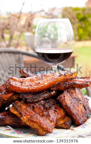 grill meat on a plate with glass of wine. Garden style