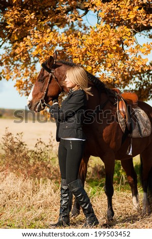 beautiful woman walking with horse and oak tree as background