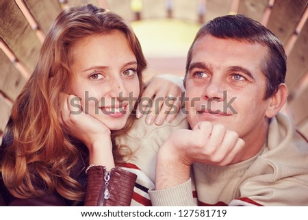 couple stand side by side and looking at the camera