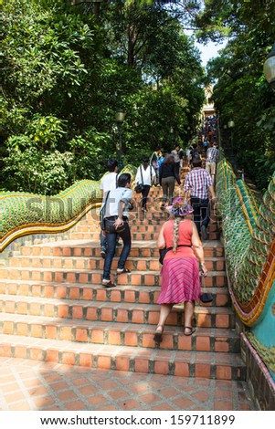 CHIANGMAI - OCTOBER 14:Tourists come to pray at the Doi Suthep Temple in Chiang Mai, Thailand on October 14, 2013. The temple founded in 1385 is a major tourist attraction in Chiang Mai.