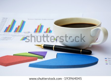 Finance chart with coffee and pen