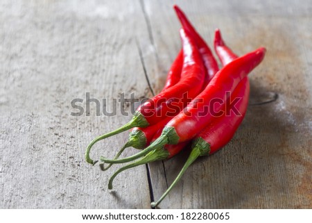 bunch of red chillies on rustic wooden background