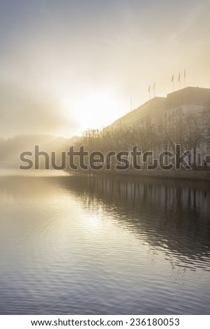 Sun shining through the fog over the alster in downtown Hamburg