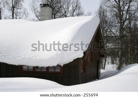 Wooden cabin, covered in a LOT of snow, Norway.