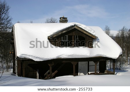 Wooden cabin, covered in a LOT of snow, Norway.