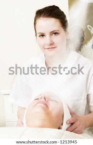 Steam treatment during a facial at a beauty spa.