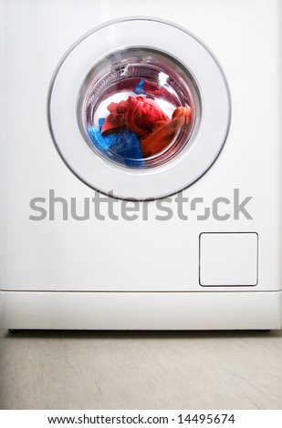 Washing machine detail with colorful clothes