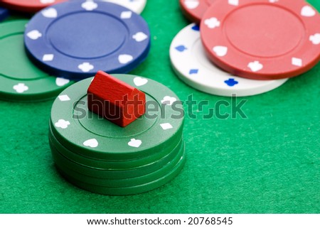 Casino chips with toy house - housing market gamble concept
