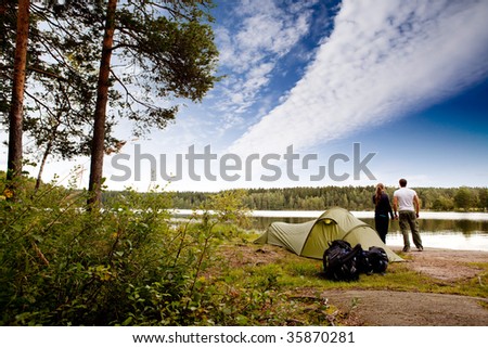 A couple camping on a lake landscape
