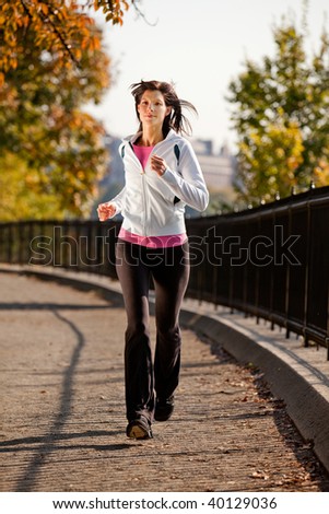 A young woman jogging in the park on a path