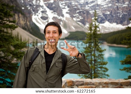 A portrait of a happy tourist in front of a scenic landscape