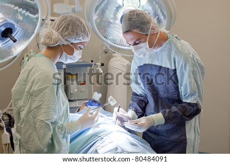 Medical doctor performing an operation on patient in operating room