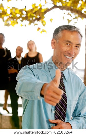 A casual business man with thumbs up
